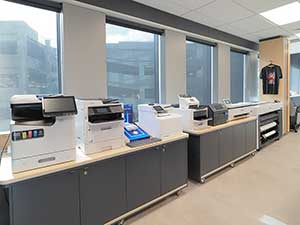 Auckland experience centre showing a large format printer and projectors projecting Epson NZ on a wall